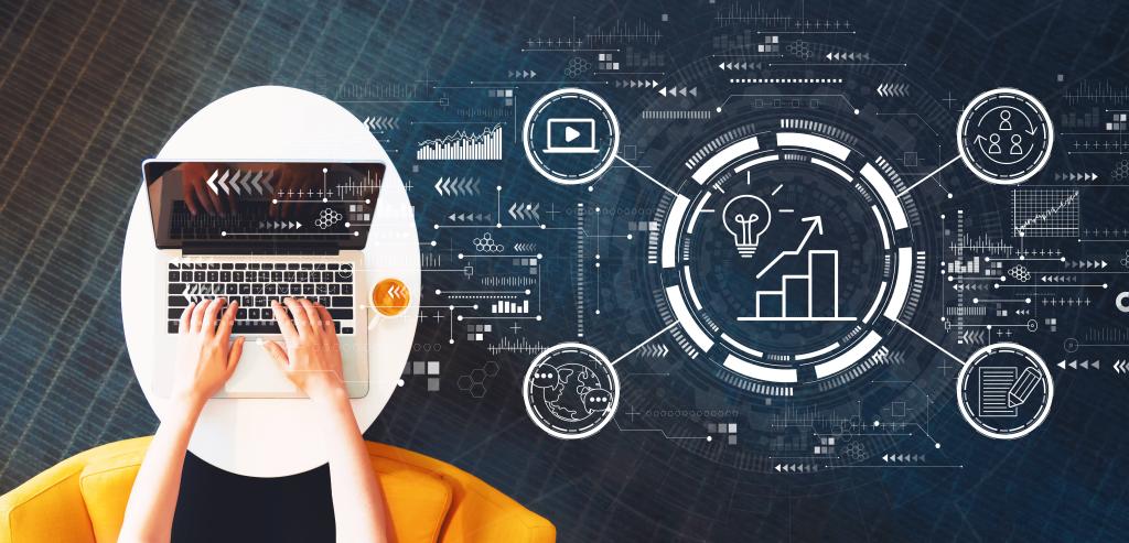 Person's hands on laptop with overlay of graphs and digital imagery.